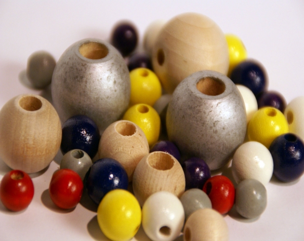 Custom wood turnings made into a variety of painted and unfinished wooden beads